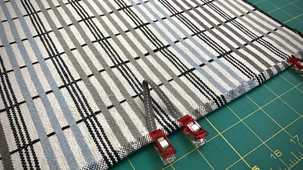 Adding handwoven band to hand towel.