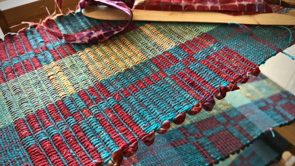 Rep weave mug rugs with fabric strips.