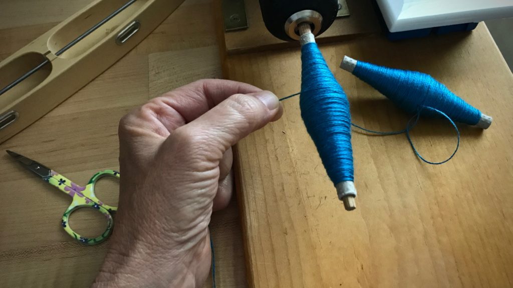 Winding quills for double bobbin shuttles.