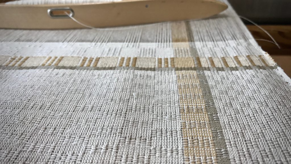 Weaving M's and O's with linen weft.