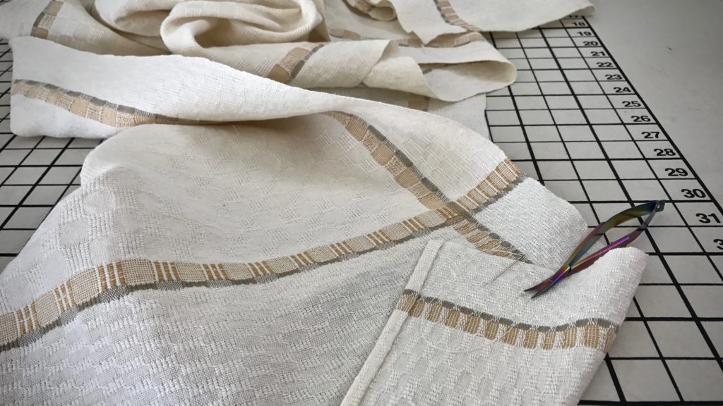 Long M's and O's table runner is hemmed by hand.