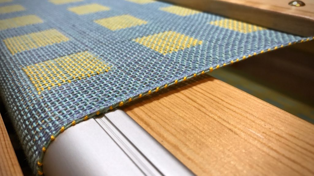 Sunshine yellow weft thread decorates the selvedge.