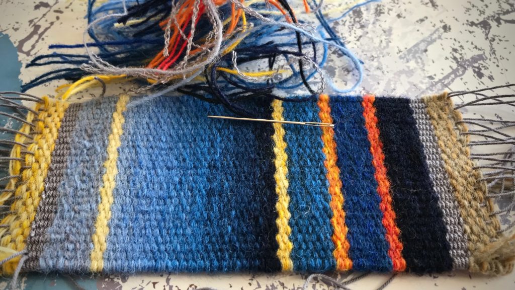 Sewing in and trimming weft tails.