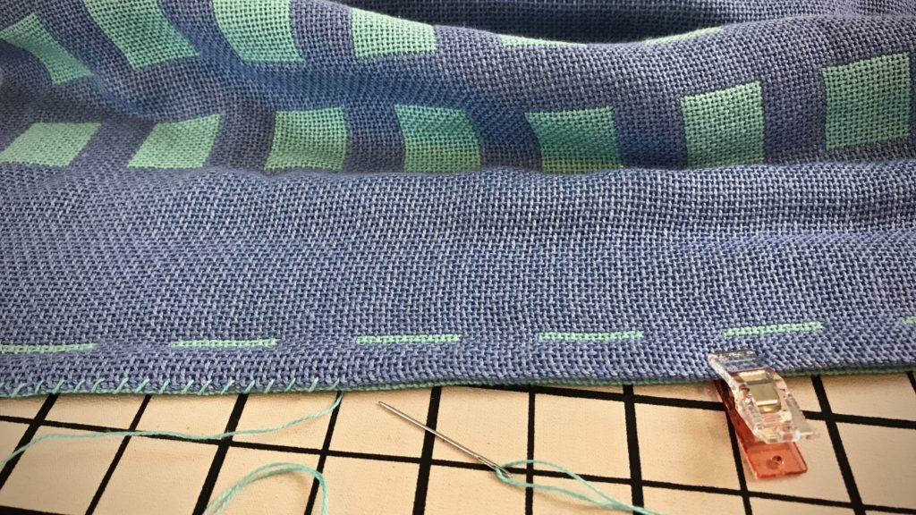 Hemming double weave baby blanket.