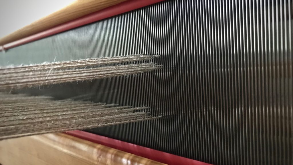 Adjusting treadles on countermarch loom.