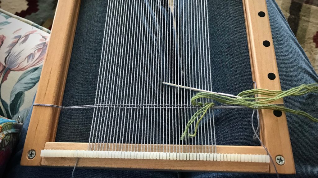 Travel tapestry loom is warped before hitting the road.