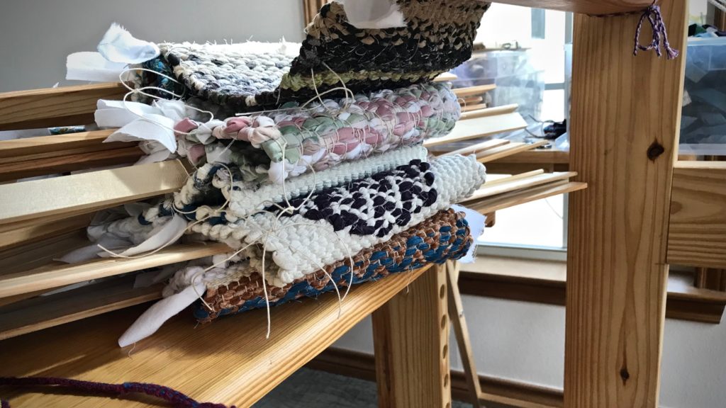 Ten rag rug hot pads are cut from the loom!