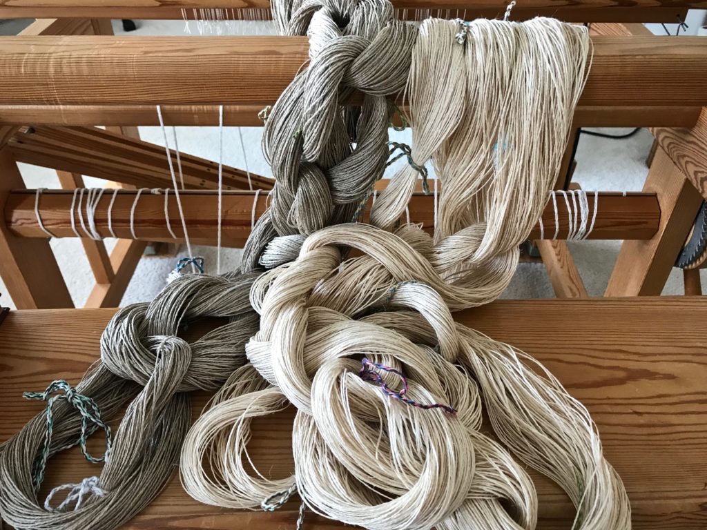 Two linen warp chains, ready for dressing the loom.