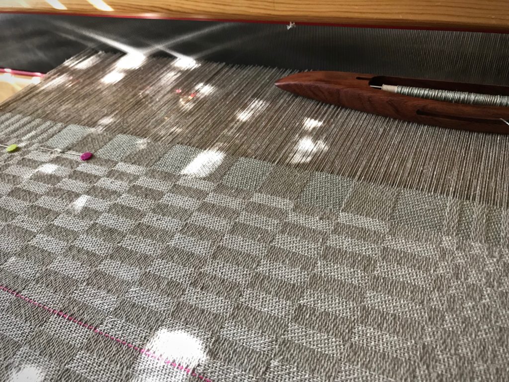 Sunlit linen damask weaving.