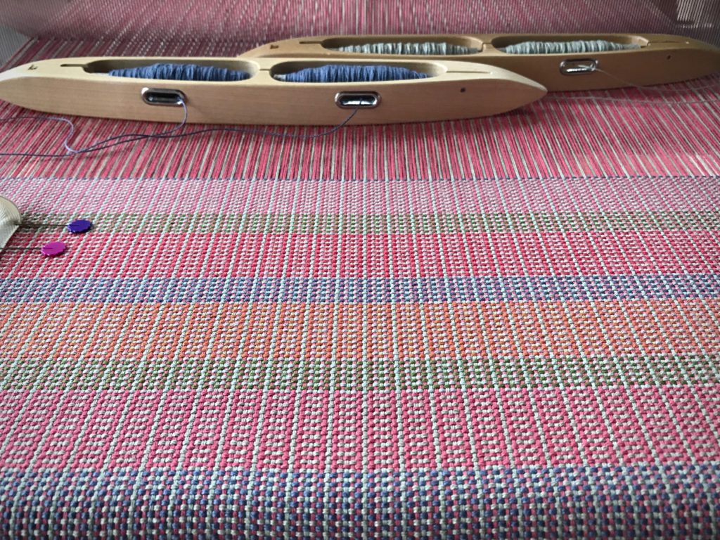 Two double-bobbin shuttles with color and weave.