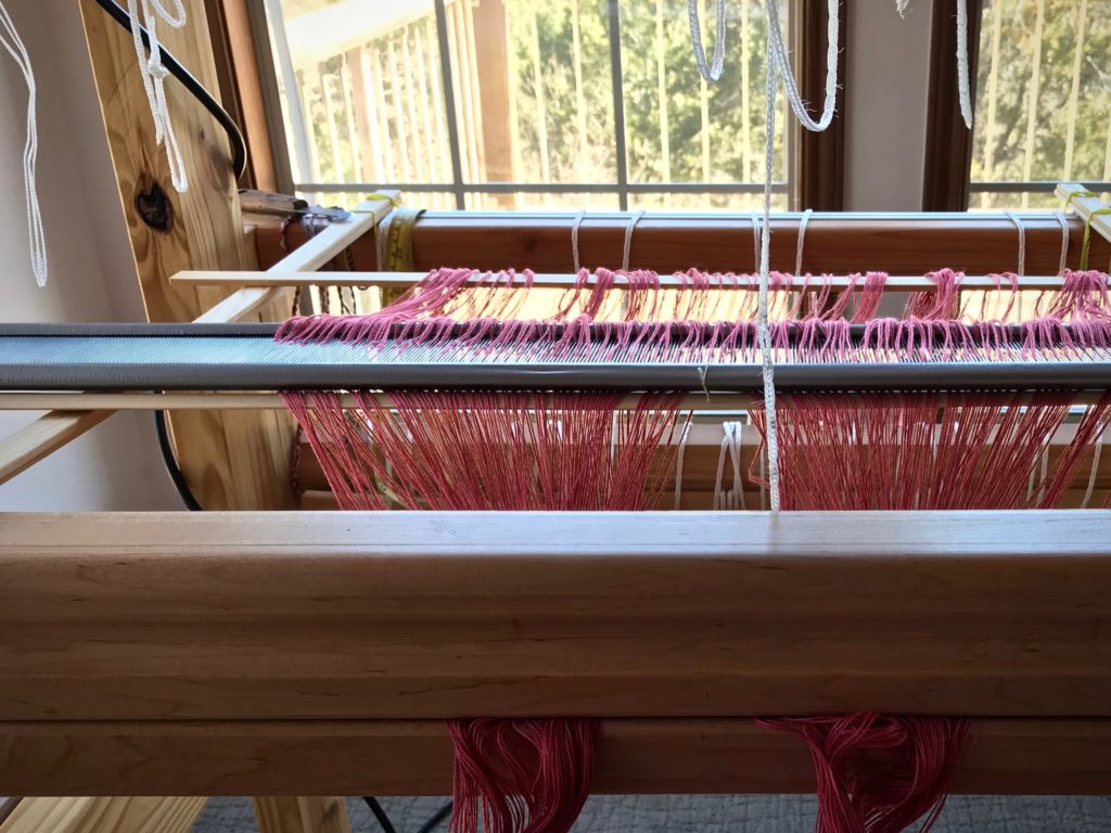 Preparing the loom for weaving.