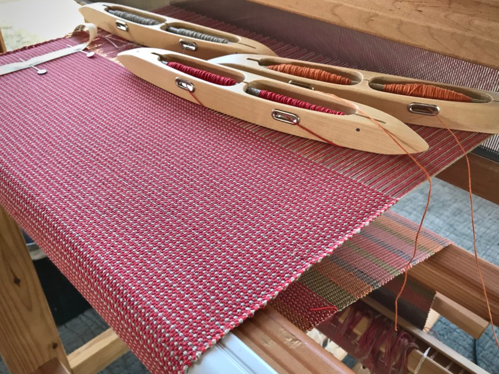 Double-bobbin shuttles for weaving doubled weft.