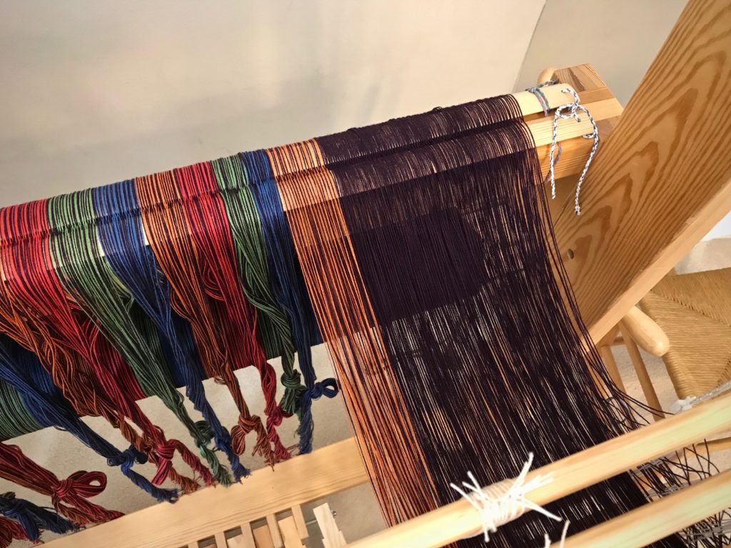 Threading heddles, from right to left.