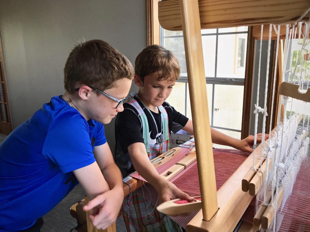 Young weavers at the loom.