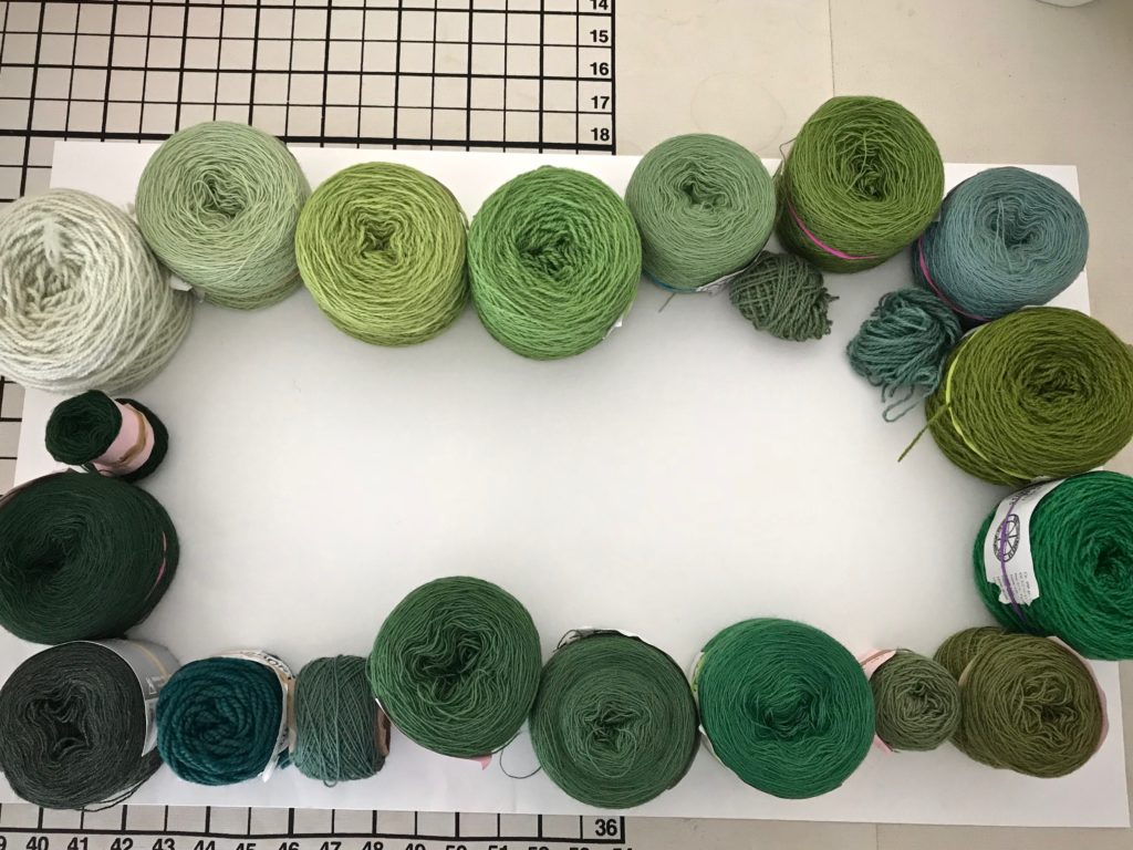 Arranging yarn by color value for tapestry.