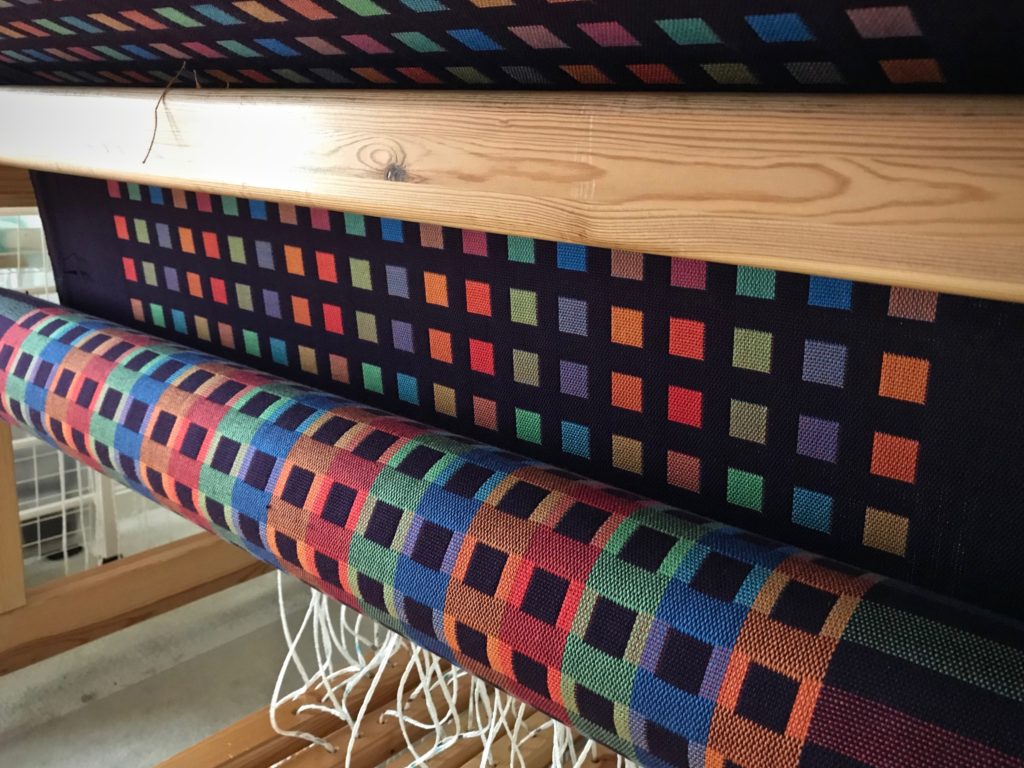 Double weave throw wrapping around the cloth beam.