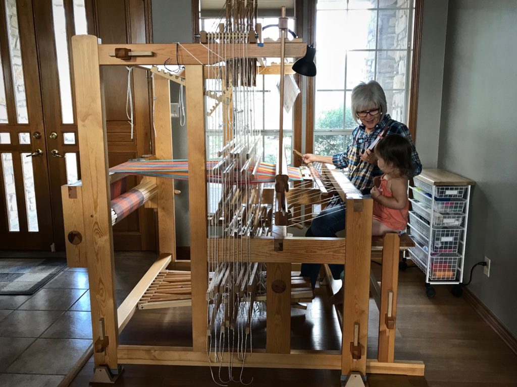 Weaving with my granddaughter at my side.