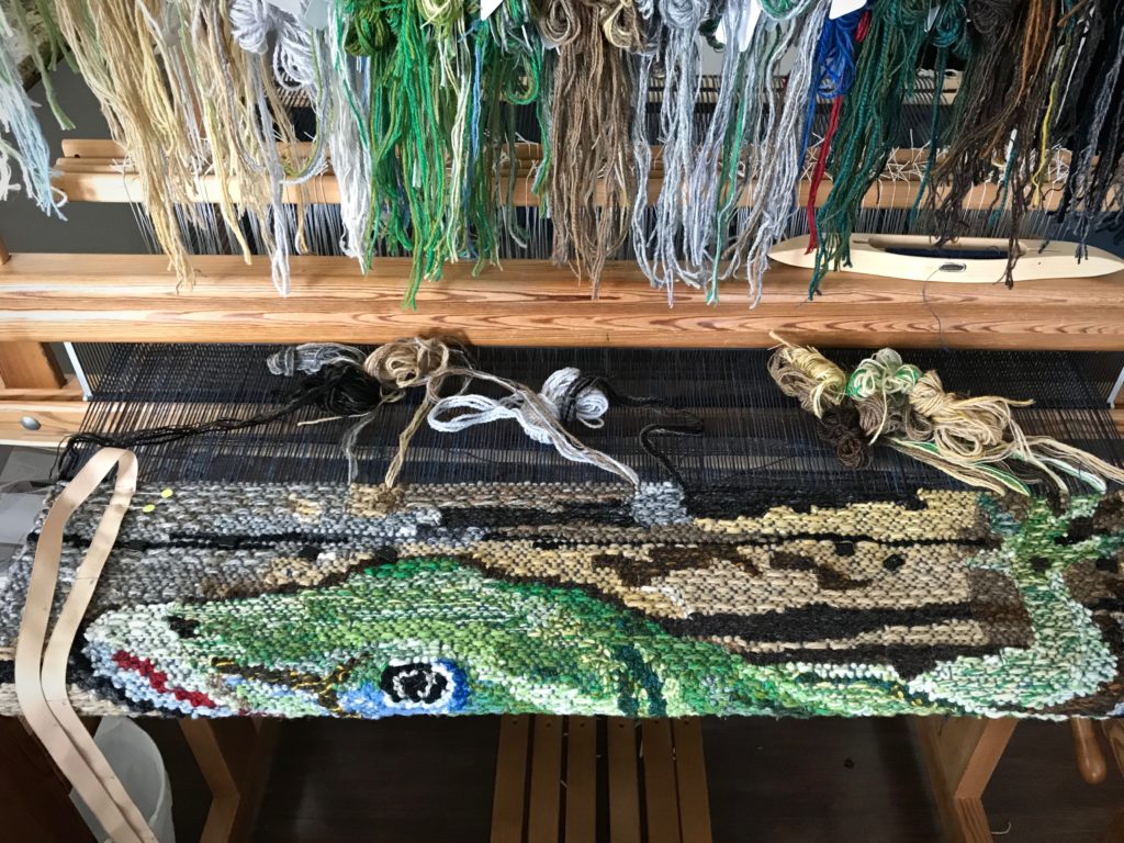 Lizard tapestry. Only the tips of the toes are left.