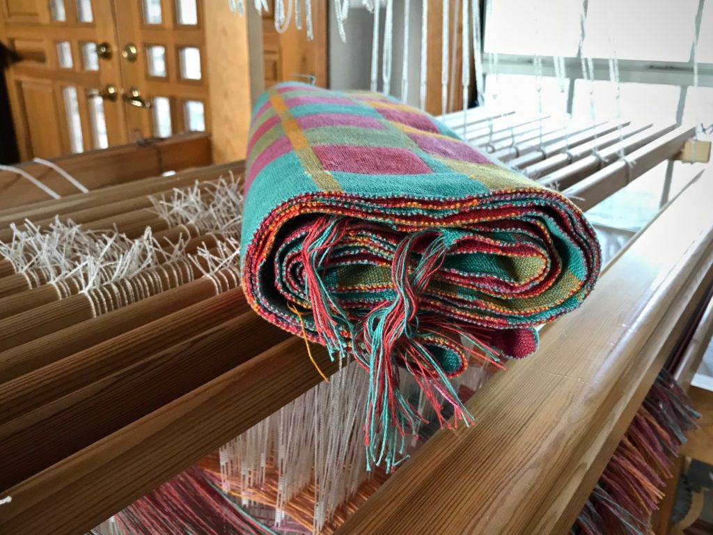 Freshly woven towels, ready for finishing work.