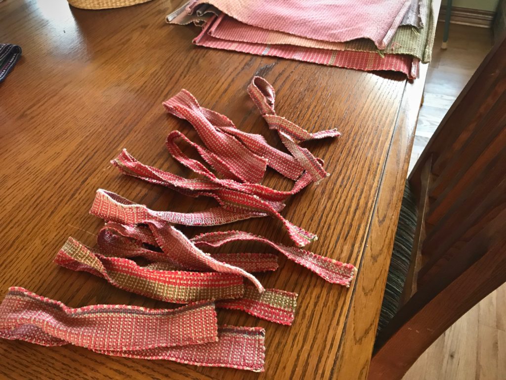 Luggage ribbons made from handwoven scraps.