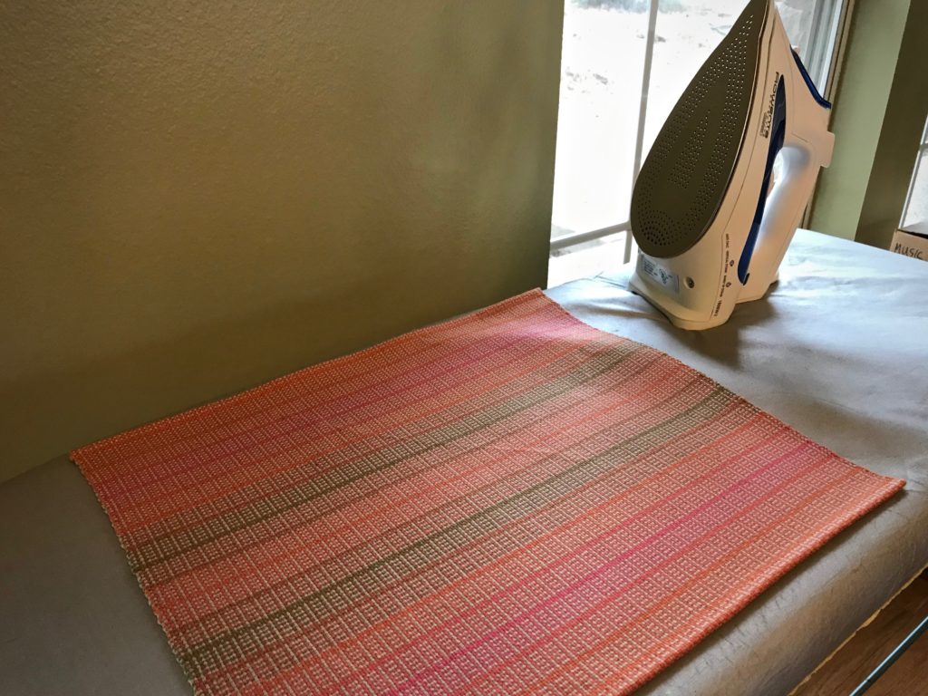 Pressing handwoven placemats.