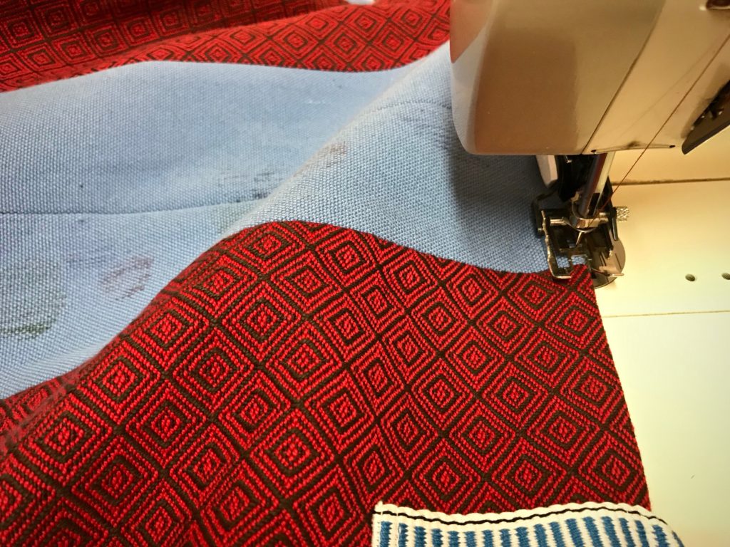 Sewing a bag from handwoven fabric.