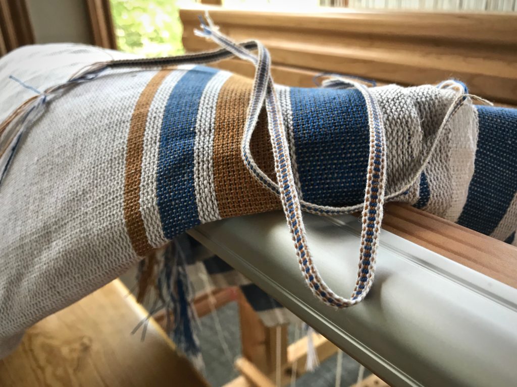 Using thrums to make coordinating tabs for handwoven towels.