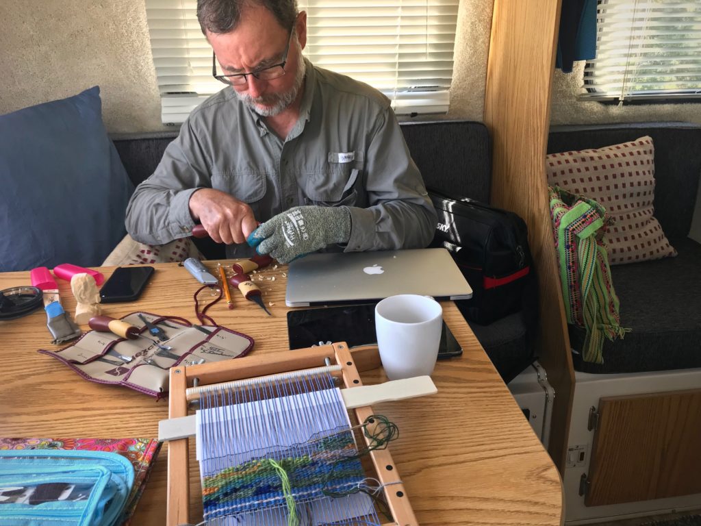 Relaxing in the Casita travel trailer. Wood carving and tapestry weaving.