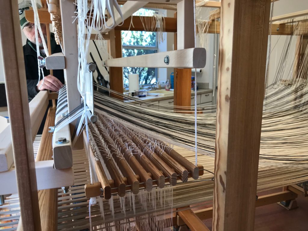 Placing the single-unit reed on the drawloom.