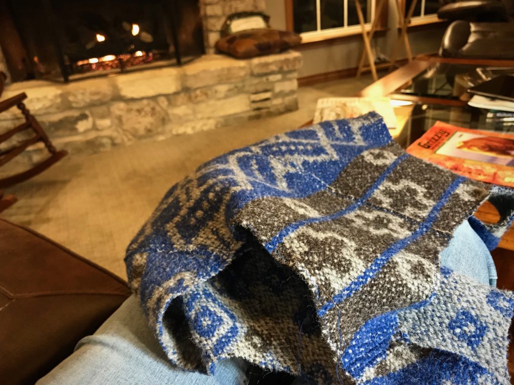 Hand-stitching work by the fireplace.