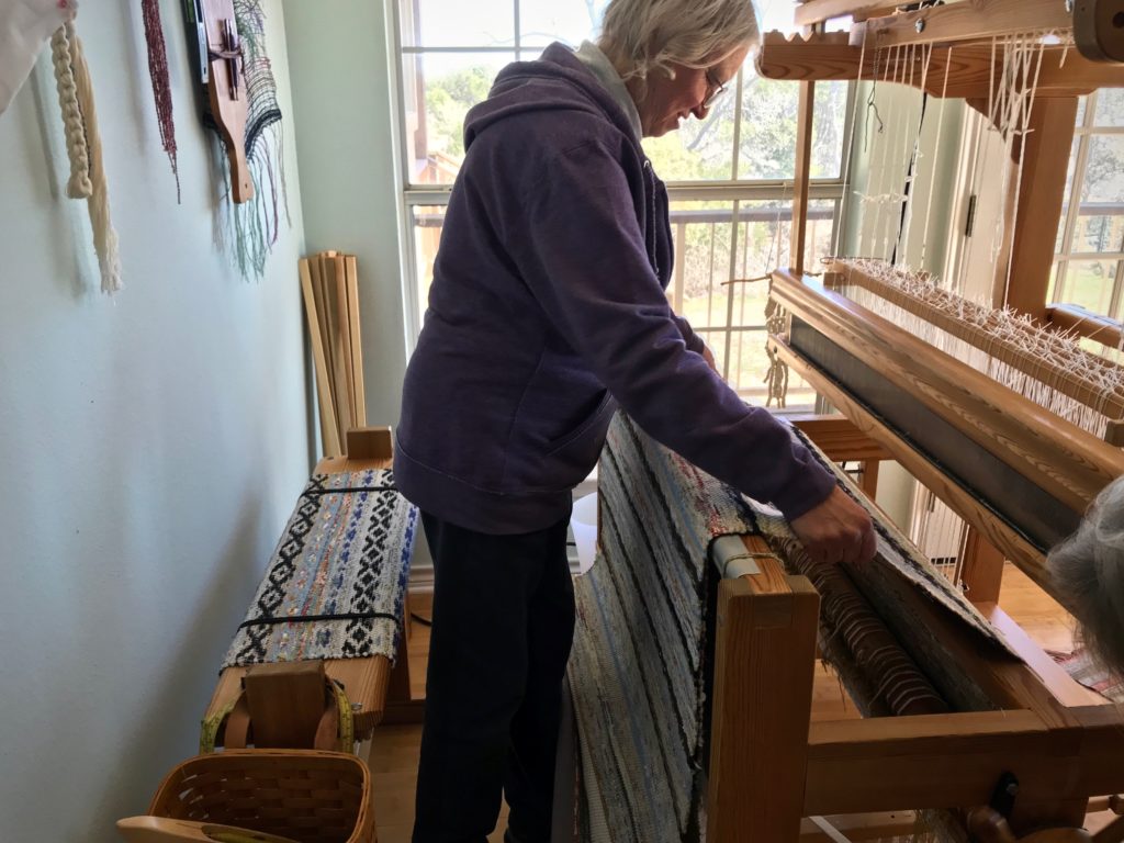 Unrolling the cloth beam with new rosepath rag rugs.