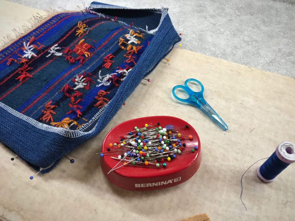 Constructing a small handwoven wool bag.