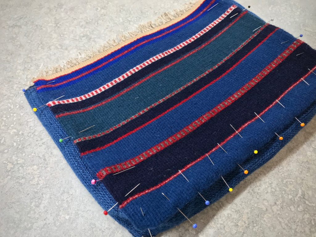 Handwoven wool bag construction.