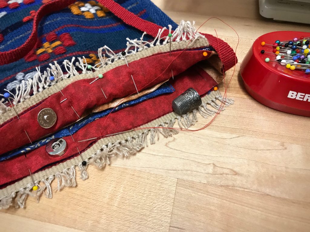 Magnet closure on a handwoven bag.