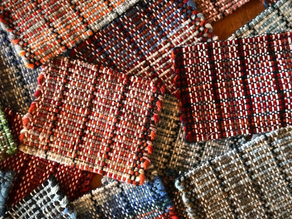 Handwoven wool coasters woven on a rigid heddle loom.