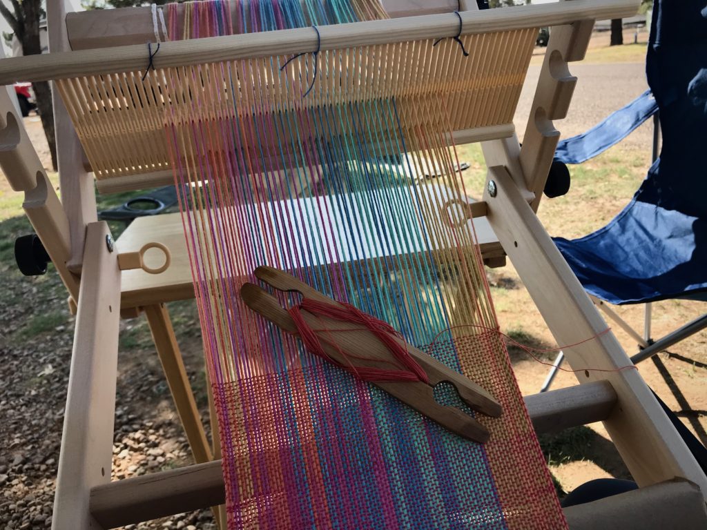 Weaving outside while camping.