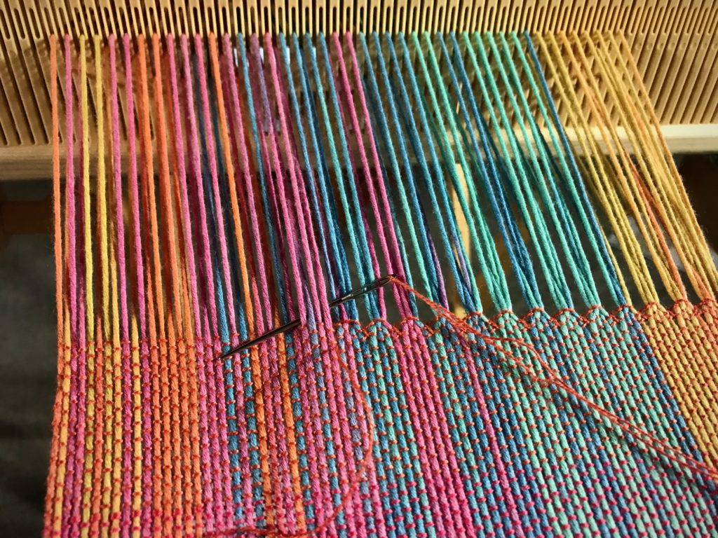 Hemstitching at the end of a scarf on the rigid heddle loom.