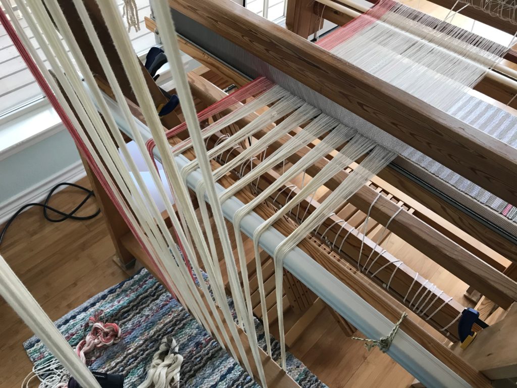 Beaming the warp with a trapeze.