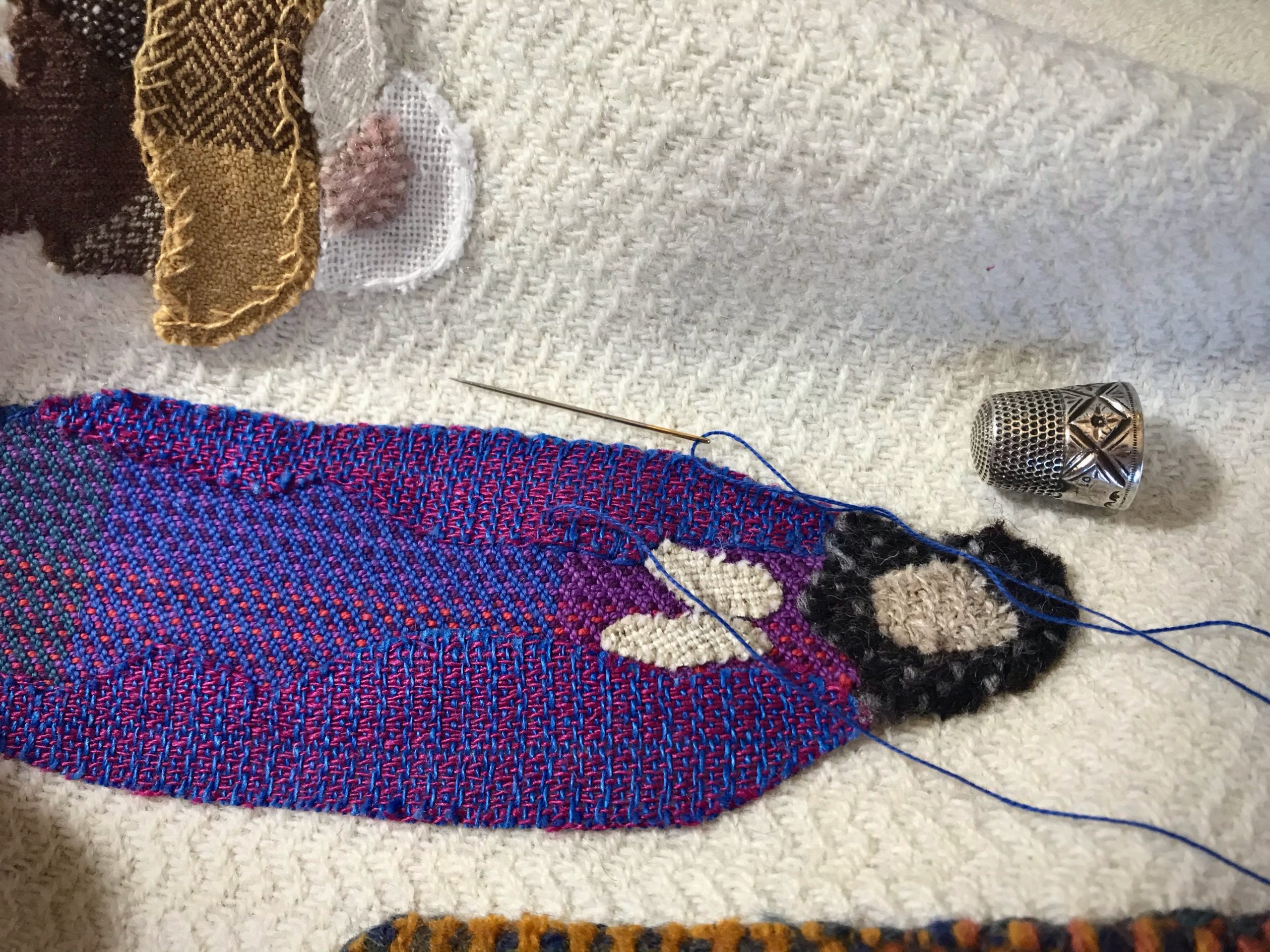 Stitching handwoven applique.