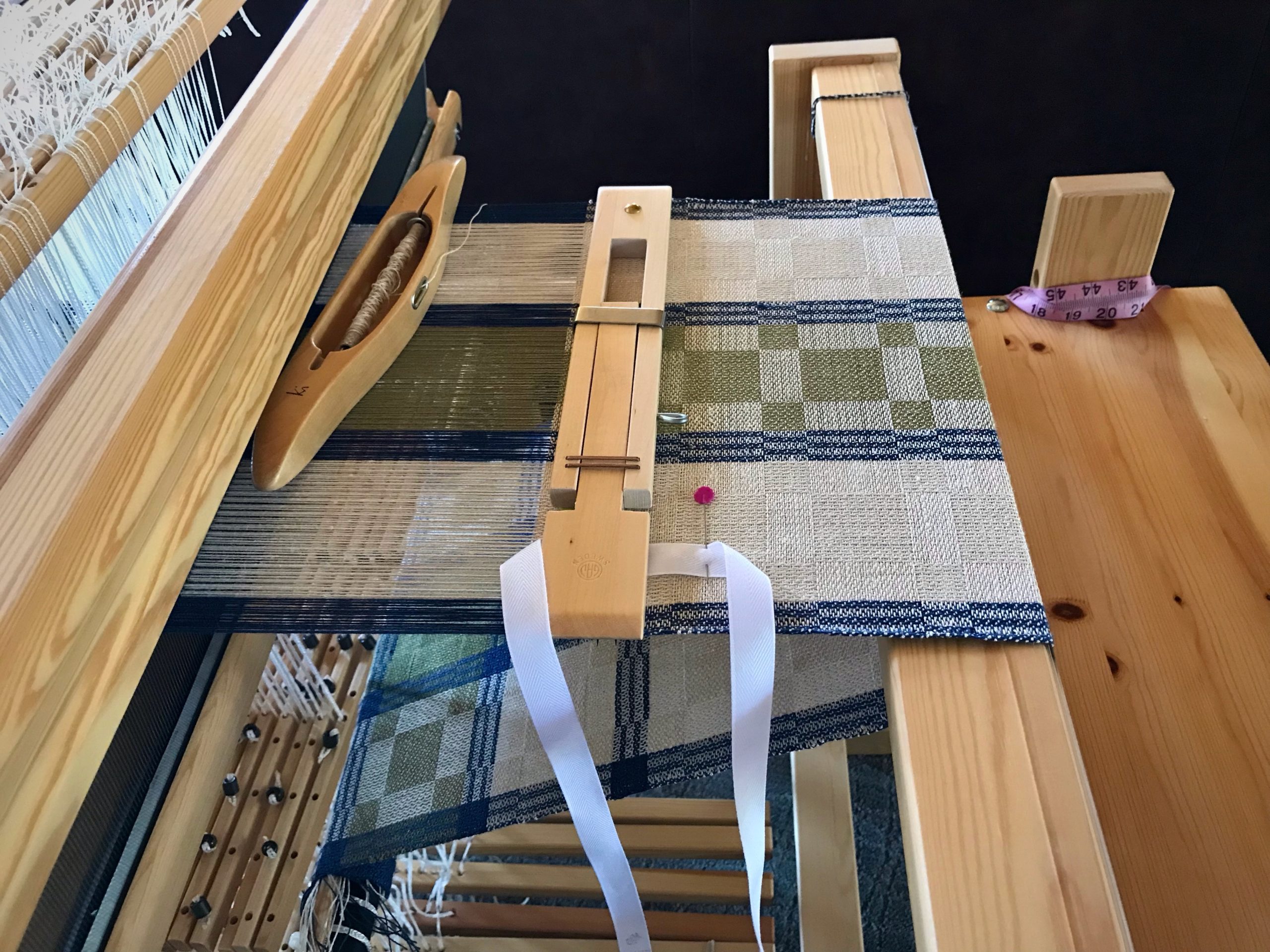 Weaving a linen table runner.