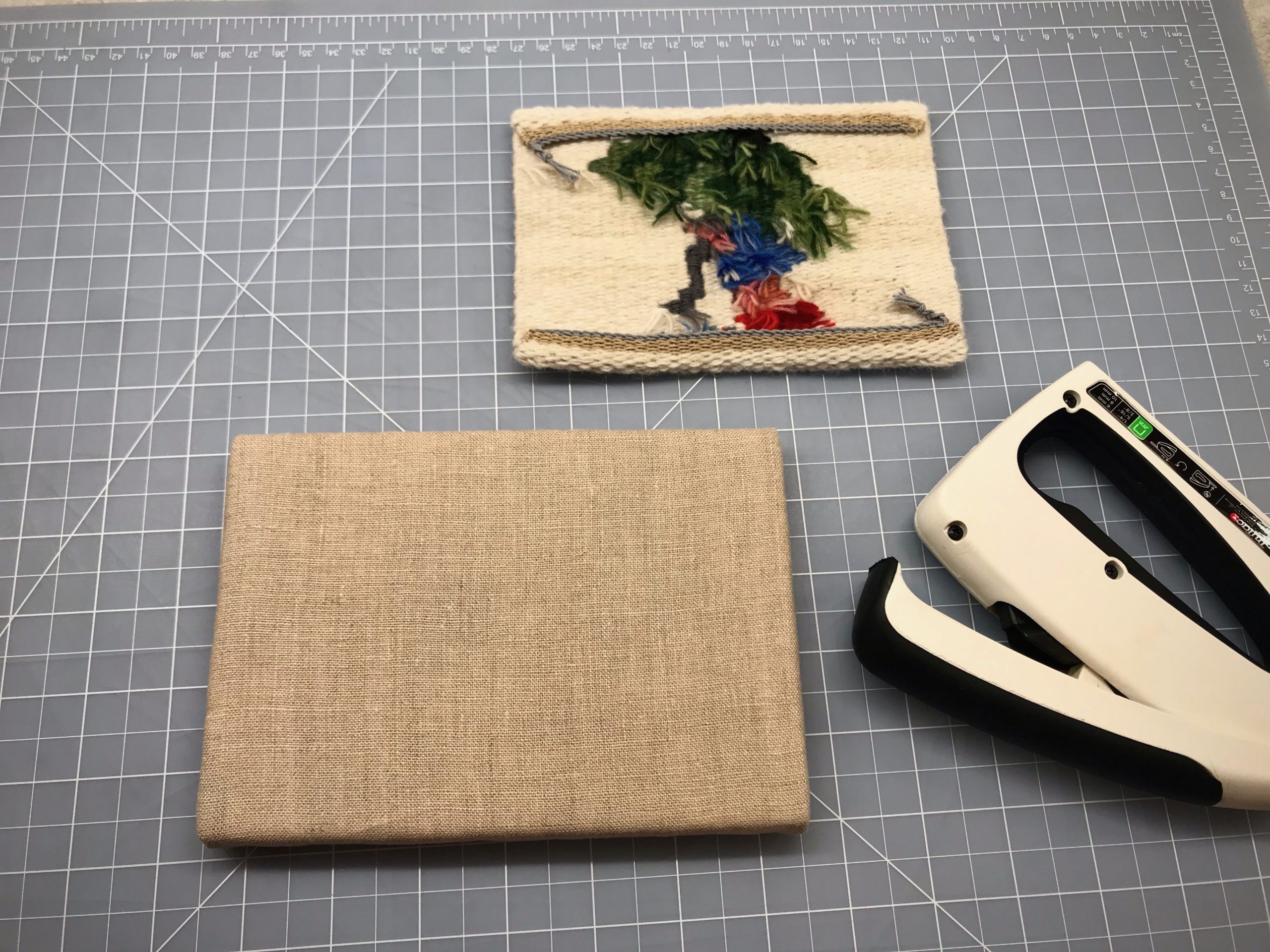Mounting a small tapestry on foam core board covered with flannel and linen.