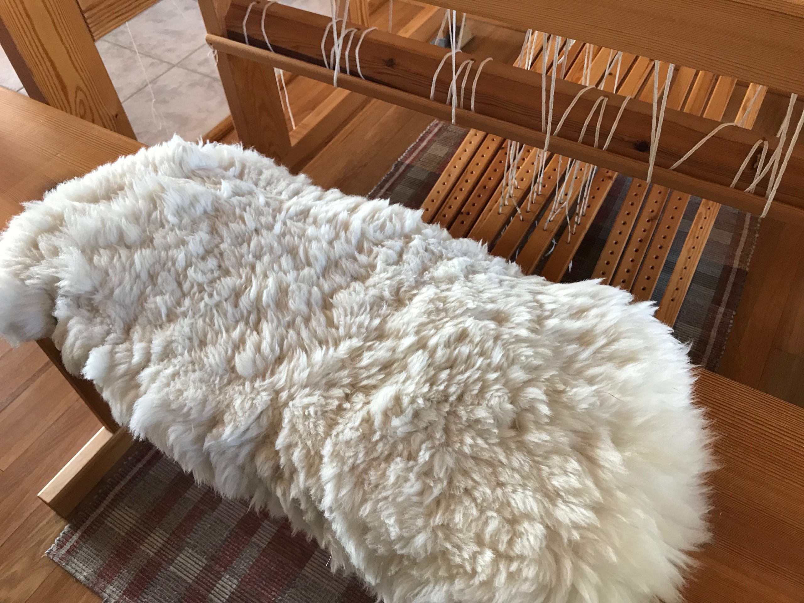 Tried and True Sheepskin Loom Bench Cover Warped for Good